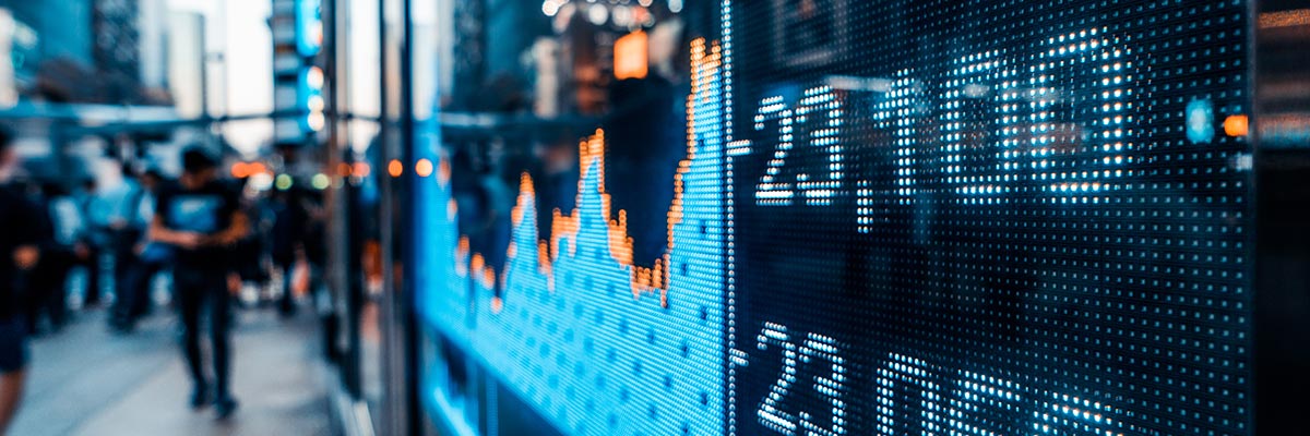 Share prices and graphs displayed on an electronic board