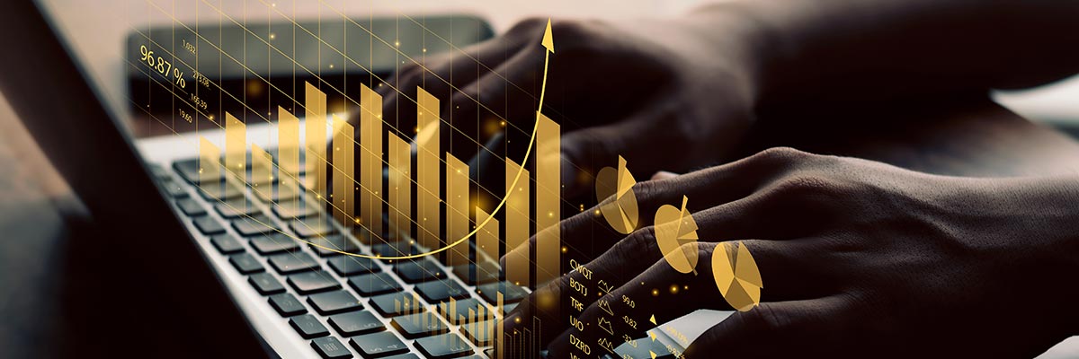 Person working on a laptop displaying a virtual graph of profit and loss