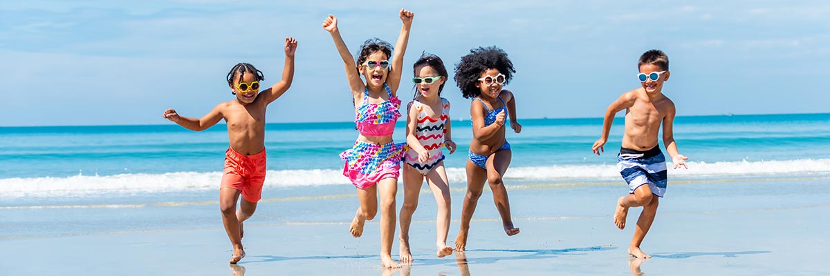 Happy kids running on the beach