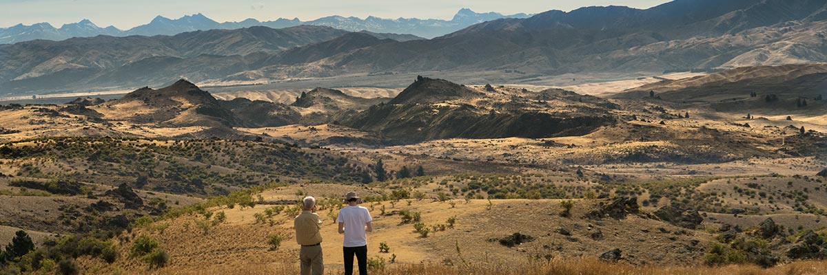 Two farmers looking out across the parched High Country