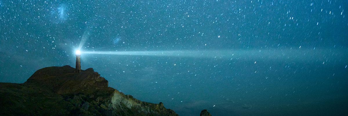 Lighthouse against a starry sky