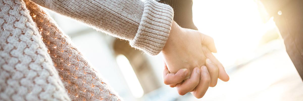 Two people holding hands