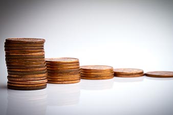 A pile of coins decreasing in size over time