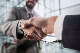 Two men shaking hands over a deal