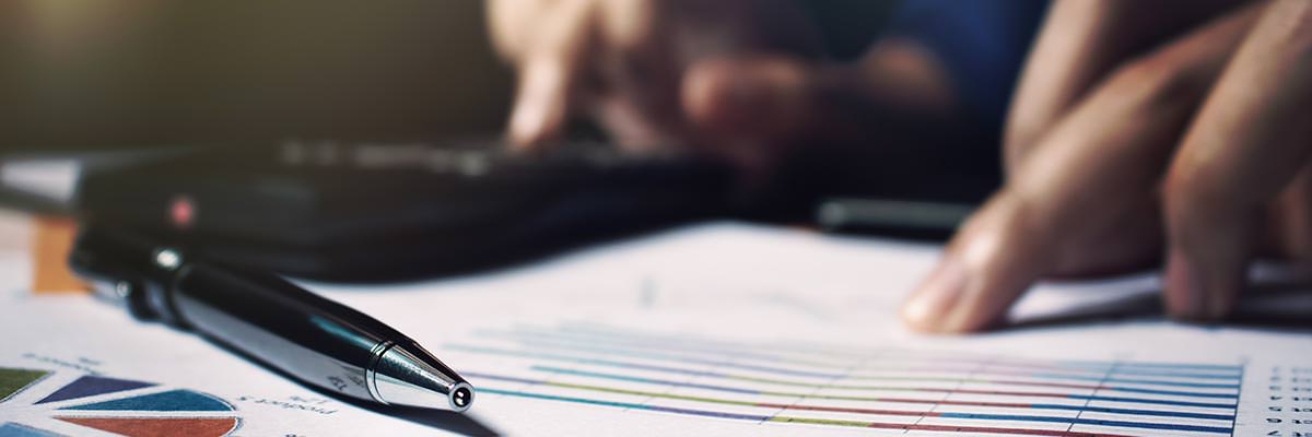 Closeup of person working on investment calculations