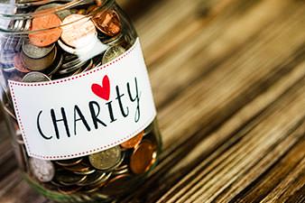 Charity collection jar full of coins